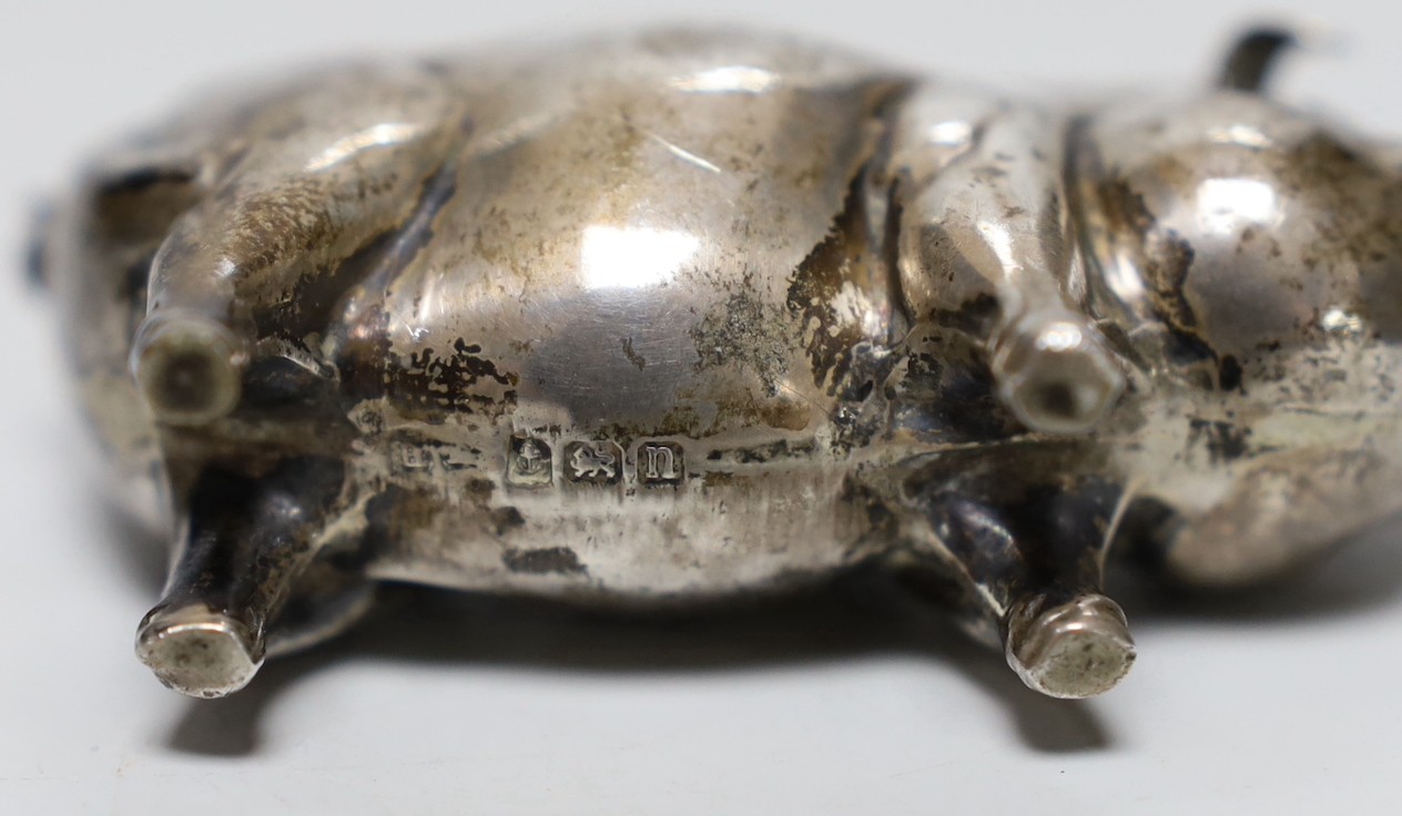 A George V silver mounted pig pin cushion, H?, Birmingham, 1912, length 77mm.